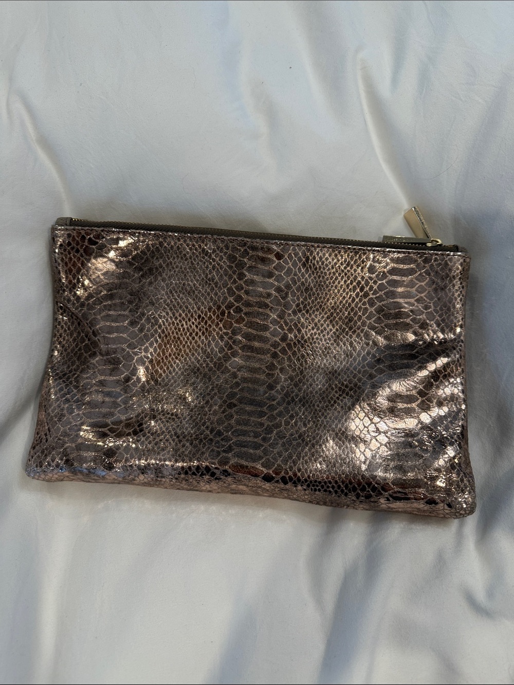 Leather Zip reversible clutch in Metallic taupe and reverses to rose gold